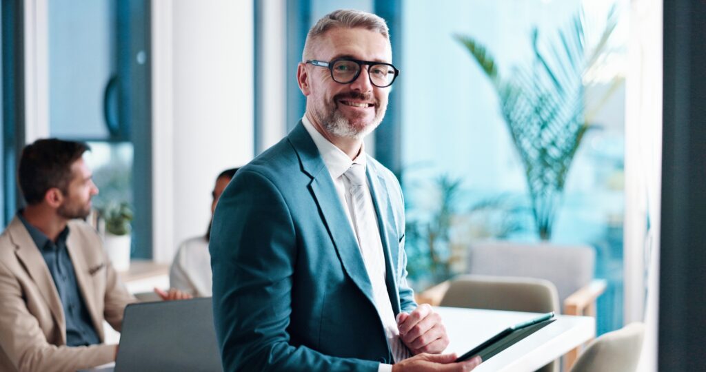 Mature businessman, tablet and portrait in office, corporate investor and coworking. Smile, financi