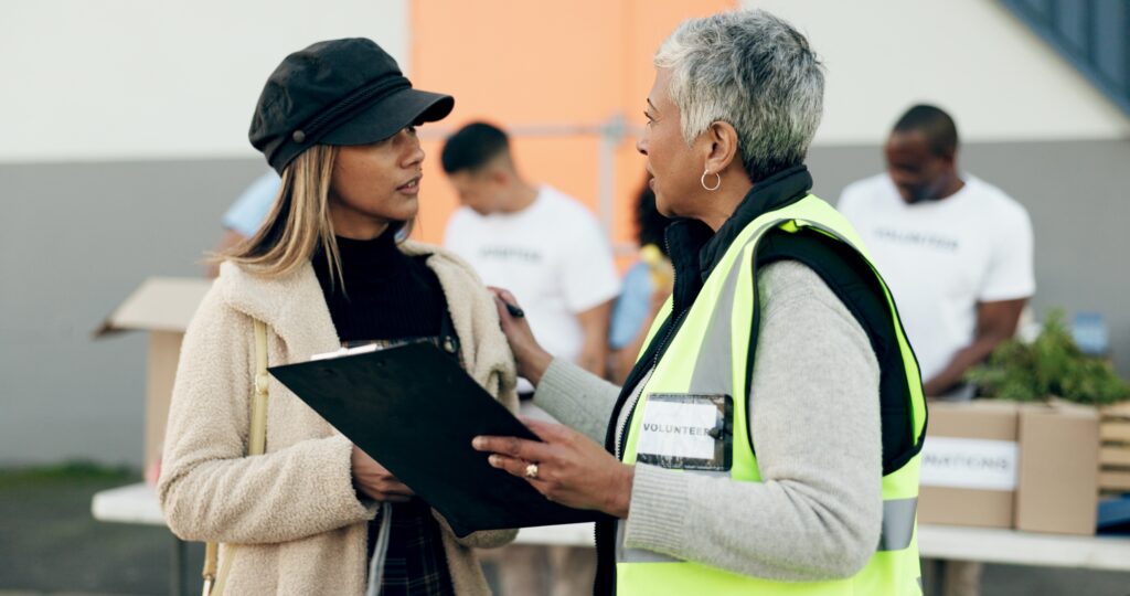 Women volunteering, checklist and food donation, NGO project or community service management and su